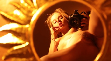Alluring babe shows her hairy pussy while taking naked selfies in a mirror