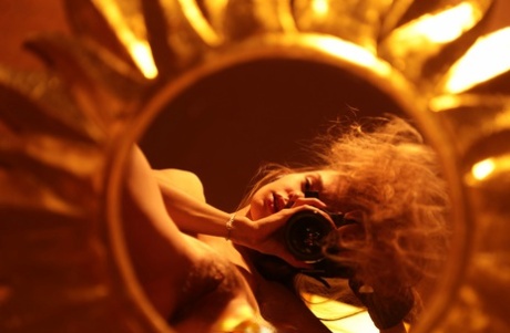 Alluring babe shows her hairy pussy while taking naked selfies in a mirror