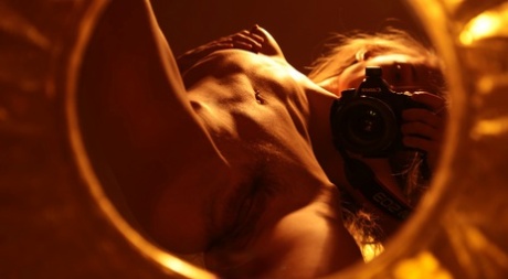 Alluring babe shows her hairy pussy while taking naked selfies in a mirror