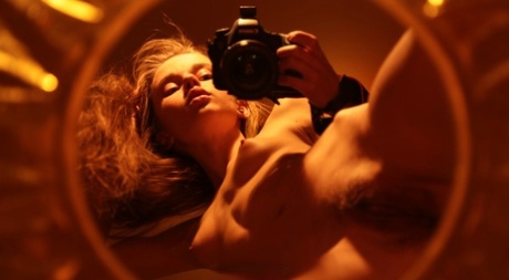 Alluring babe shows her hairy pussy while taking naked selfies in a mirror