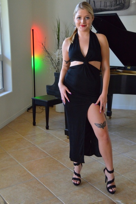Sexy blonde Jill masturbates with a white dildo while sitting at the piano