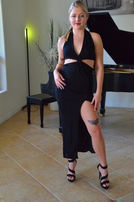 Sexy blonde Jill masturbates with a white dildo while sitting at the piano