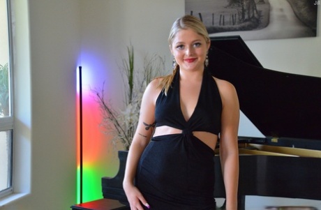Sexy blonde Jill masturbates with a white dildo while sitting at the piano